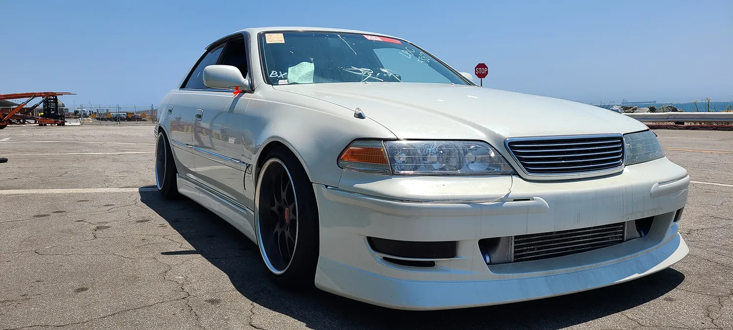 White Japanese sedan photographed at the port